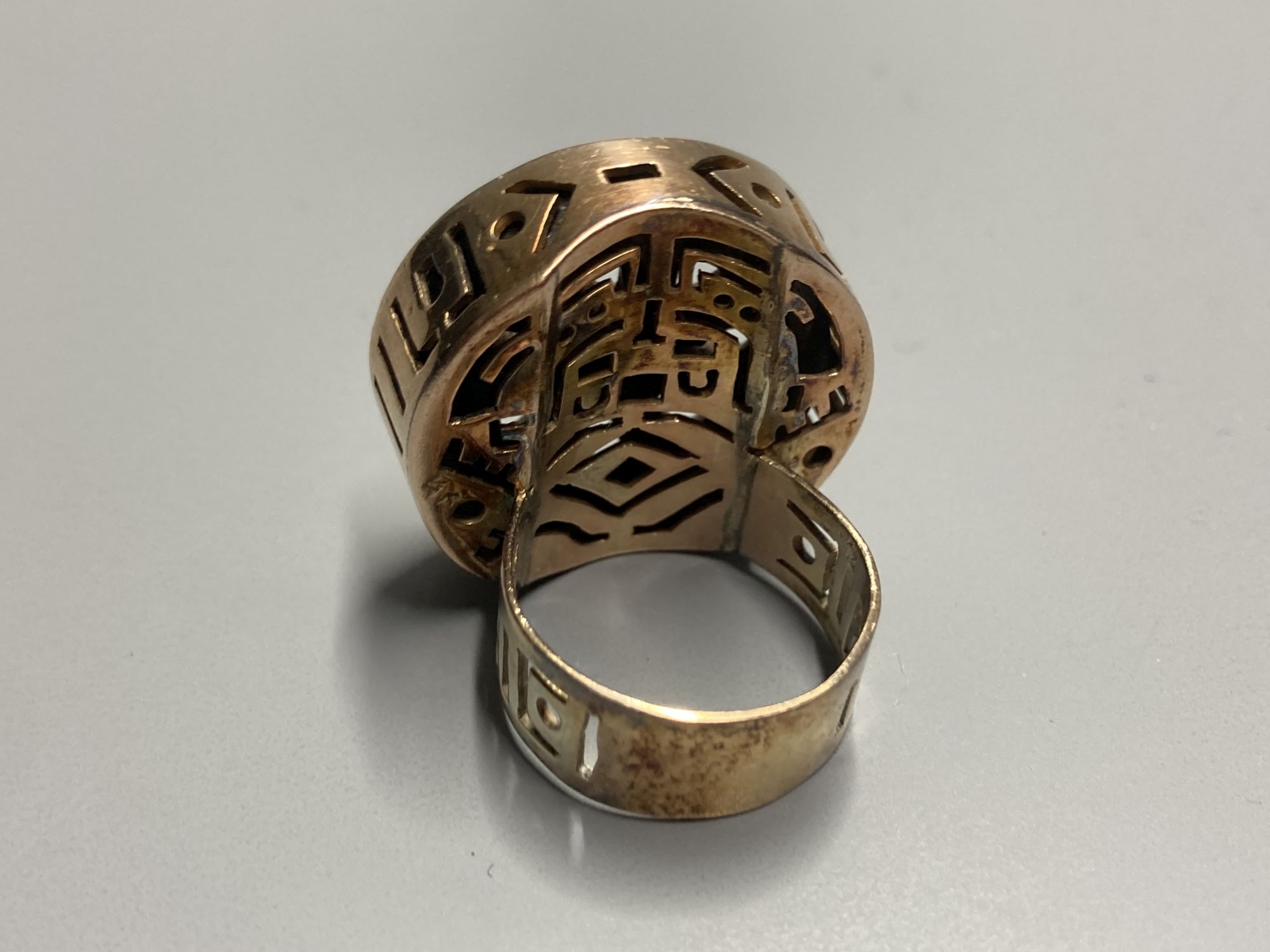 An unusual Chinese pierced gilt metal and base metal inset ring, size P, and matching pendant, overall 53mm.